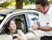 Young female driver being tested on her behind the wheel skills