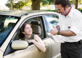 Teen in car practicing driving skills for her Texas behind the wheel test