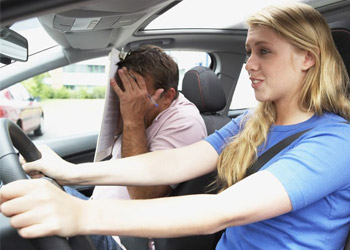 Female driver with instructor practicing her driving skills