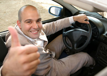 Male driver smiling after taking online driver improvement course