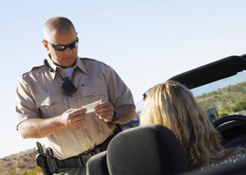 Highway patrol officer in Madera County pulling over driver for failure to observe posted speed